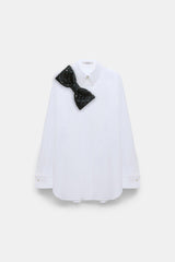 Dorothee Schumacher Crisp Cotton Poplin White Button-Up Blouse with Bow Brooch in Black Vancouver. Shop Online or in Store.
