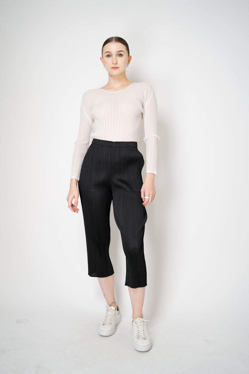 Pleats Please Issey Miyake Basics Cropped Tapered Trousers in Black Vancouver. Shop Online or in Store.