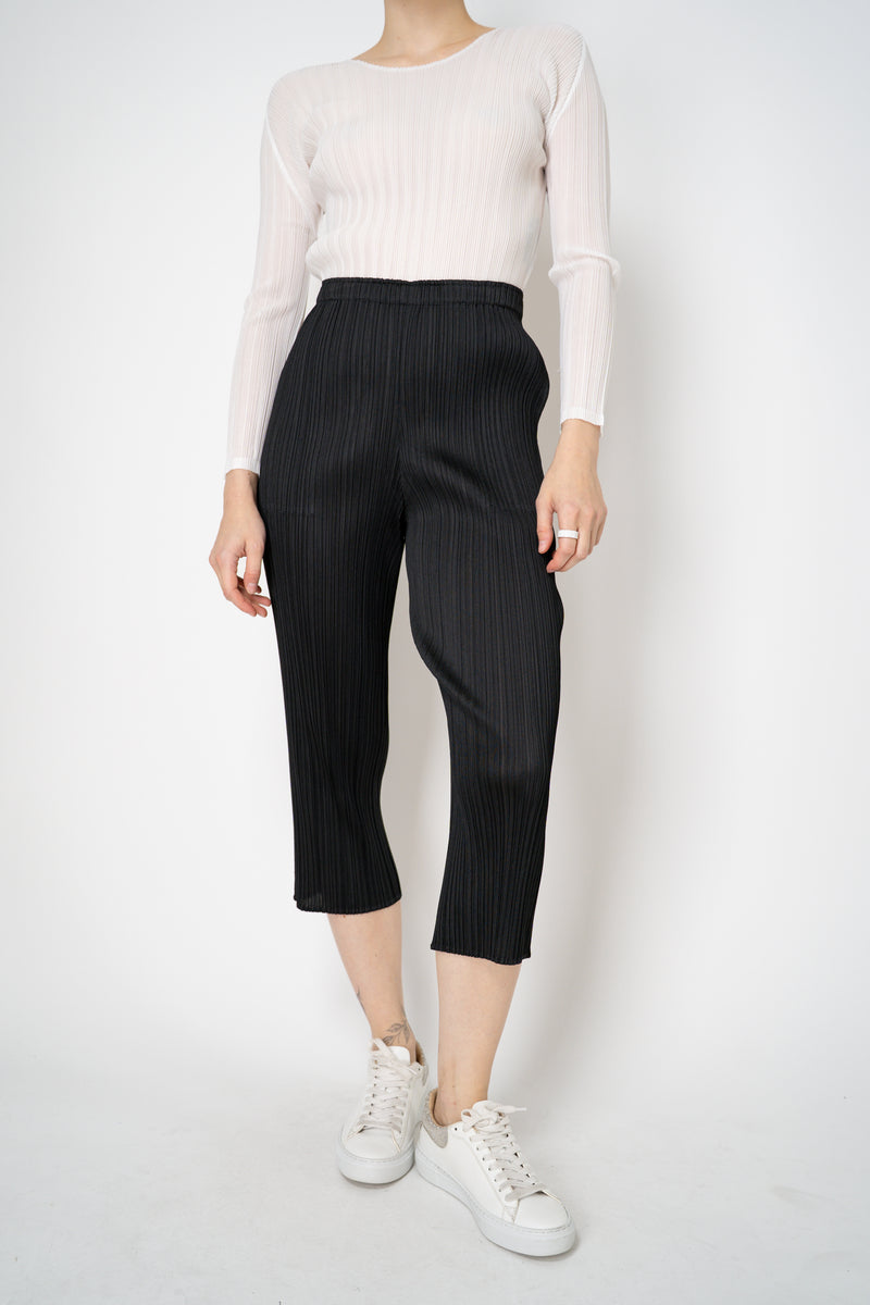 Pleats Please Issey Miyake Basics Cropped Tapered Trousers in Black Vancouver. Shop Online or in Store.