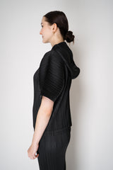 Pleats Please Issey Miyake Monthly Colors: August Hooded Short Sleeve Top in Black Vancouver. Shop Online or in Store.