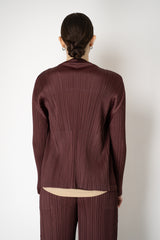 Pleats Please Issey Miyake Monthly Colors: January Drapey Lapel Cardigan in Cacao Brown Vancouver. Shop Online or in Store.