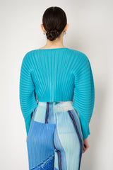 Pleats Please Issey Miyake Monthly Colors: January Rib Pleats January Cropped Bat Sleeves Cardigan in Aqua Blue Vancouver. Shop Online or in Store.