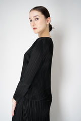 Pleats Please Issey Miyake Monthly Colors: October Round Hem Long Sleeve Top in Black Vancouver. Shop Online or in Store.