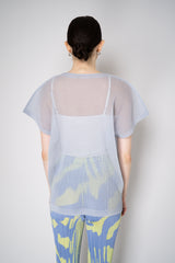 Pleats Please Issey Miyake Tatami April V-Neck Mesh Shirt in Pale Blue Vancouver. Shop Online or in Store.